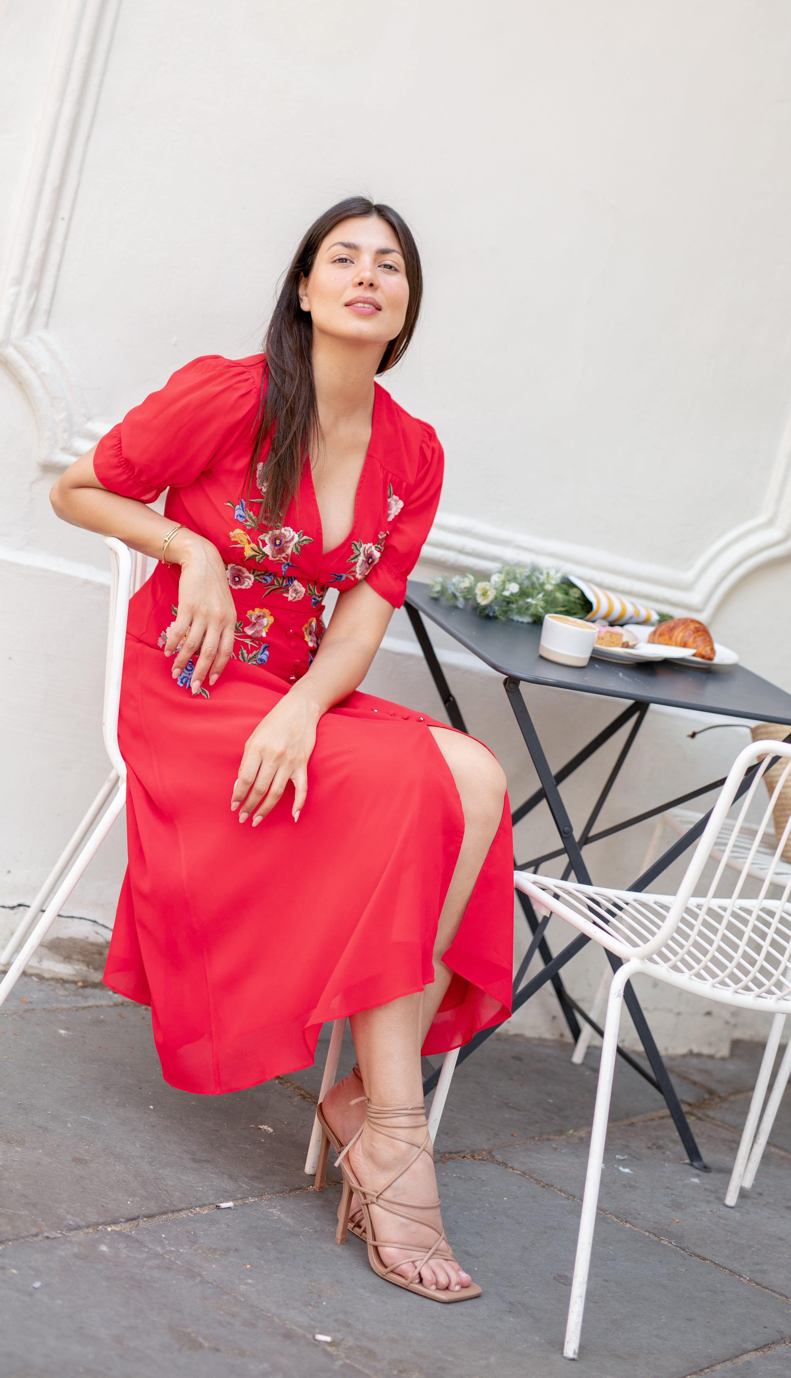 sitting at lunch with a red midi dress